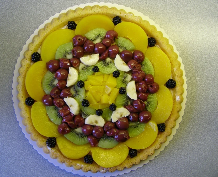 there is a small pie with fruit on top