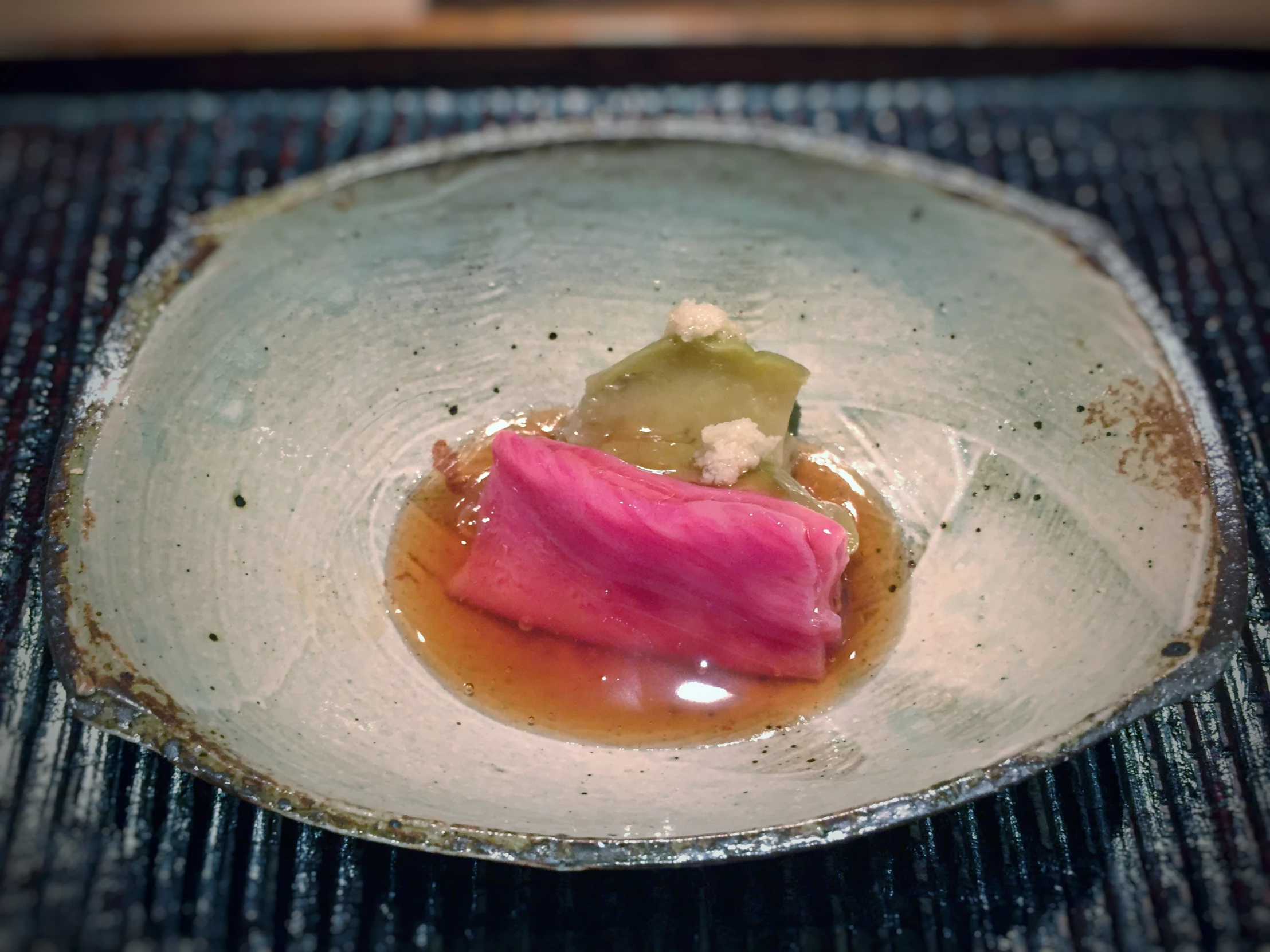 a dish with a square shaped plate holding an object in it