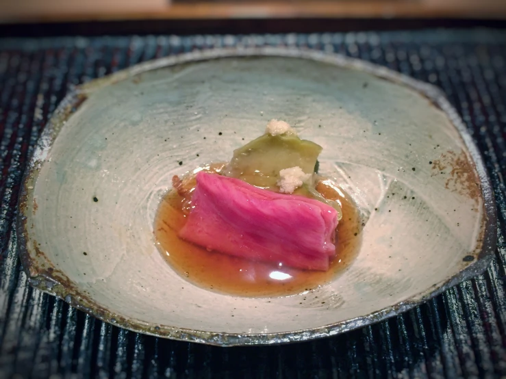 a dish with a square shaped plate holding an object in it