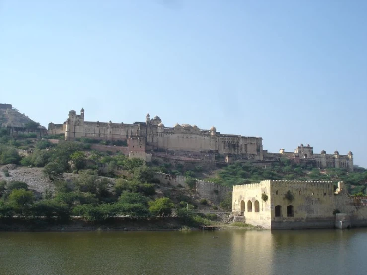 a very old palace on a hill by the water