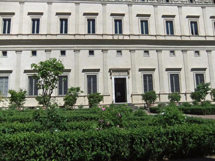 there is a statue of a bird next to some bushes