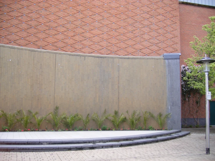 a stone fence that is next to a street sign