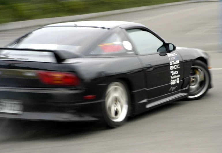 the back end of a car speeding down a road