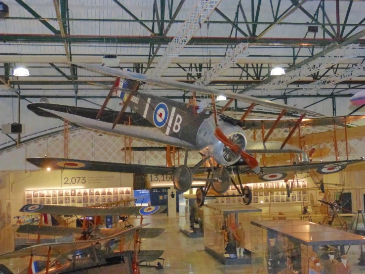 a plane sitting inside of a museum on display