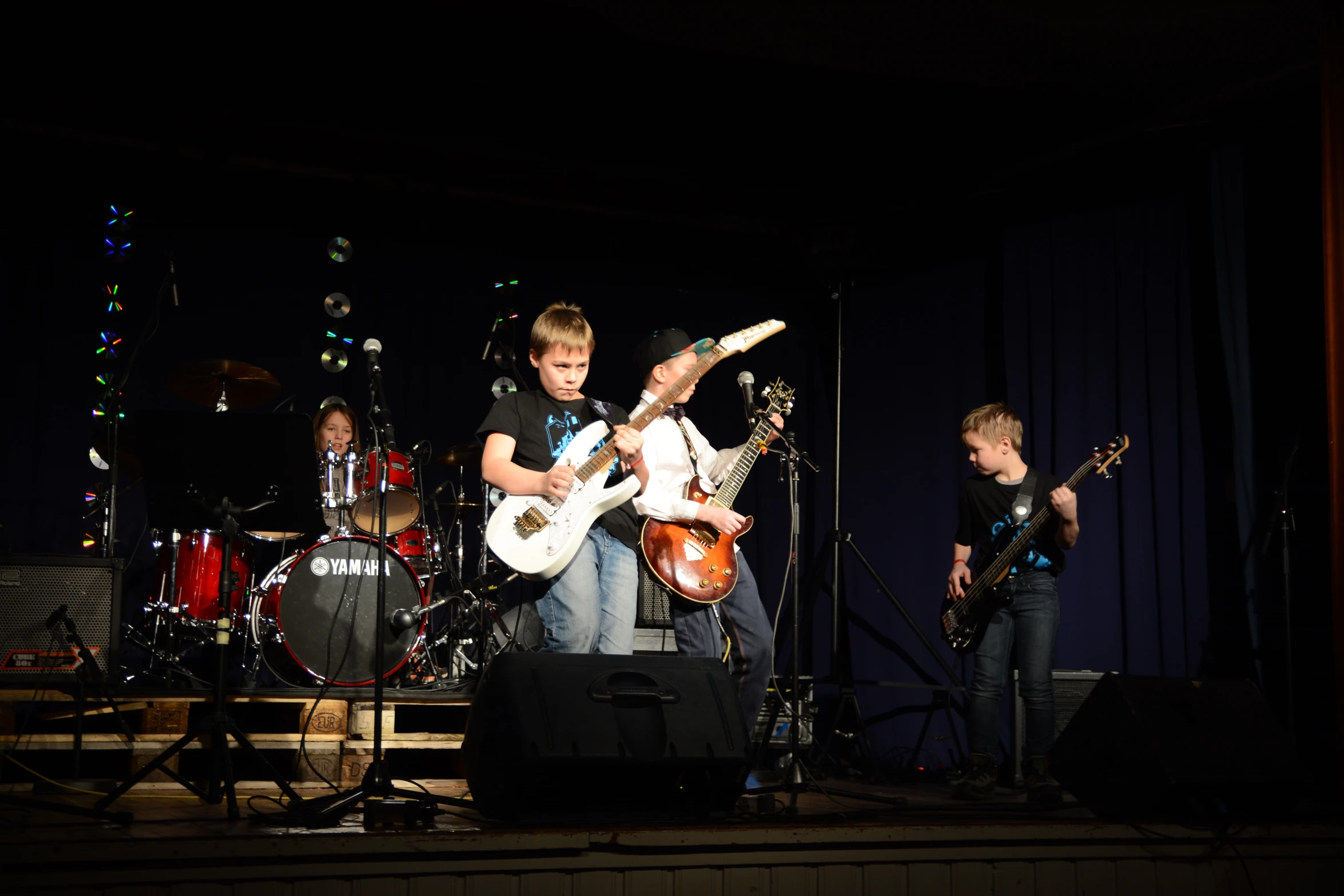 a group of children are playing on guitar and flute