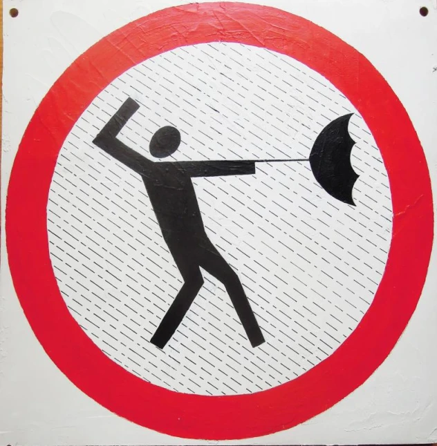 a sign with a man throwing an umbrella to hit it
