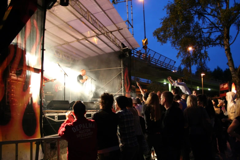 people standing on the steps next to the stage and watching a concert