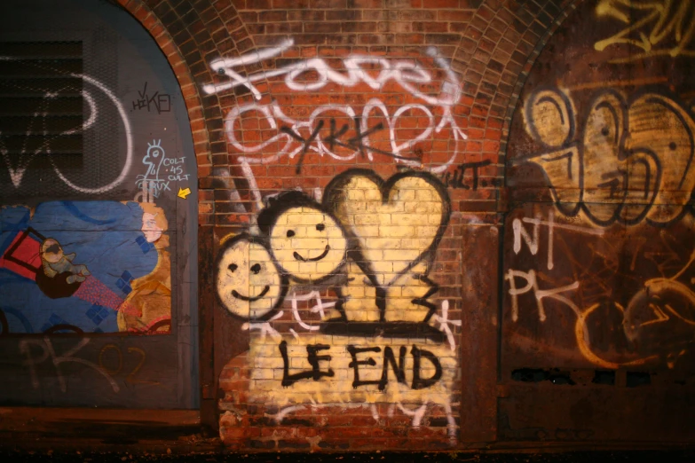 graffiti written on the side of a brick wall
