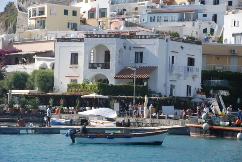 two boats tied up to the shore next to some buildings