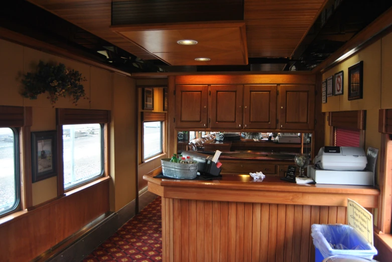 the kitchen in an rv with wood paneling