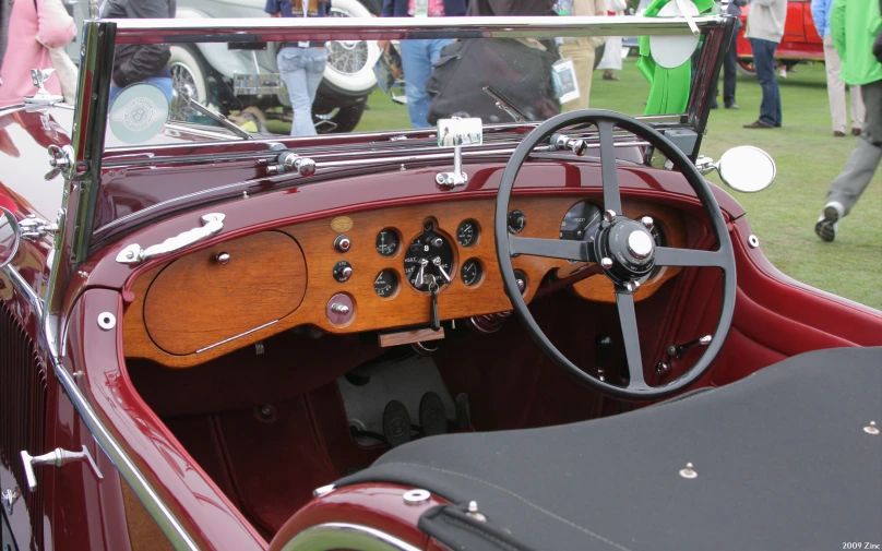 old fashioned convertible car with wood trim and steering wheel