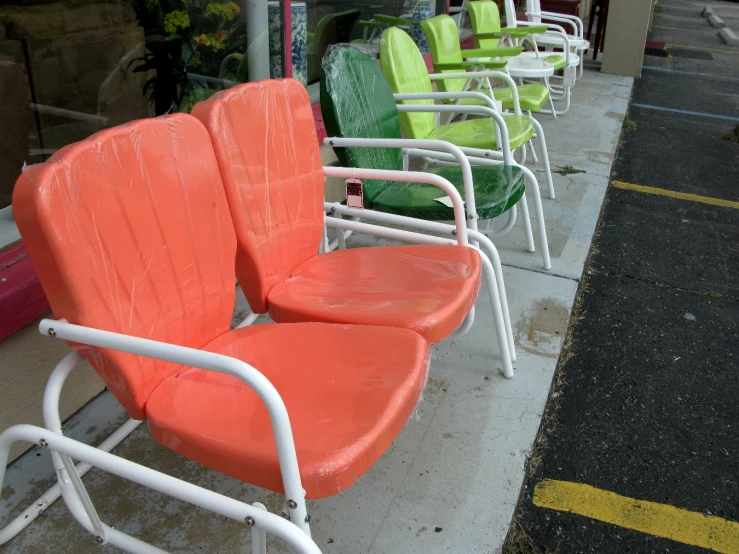 some green and orange seats sitting next to each other