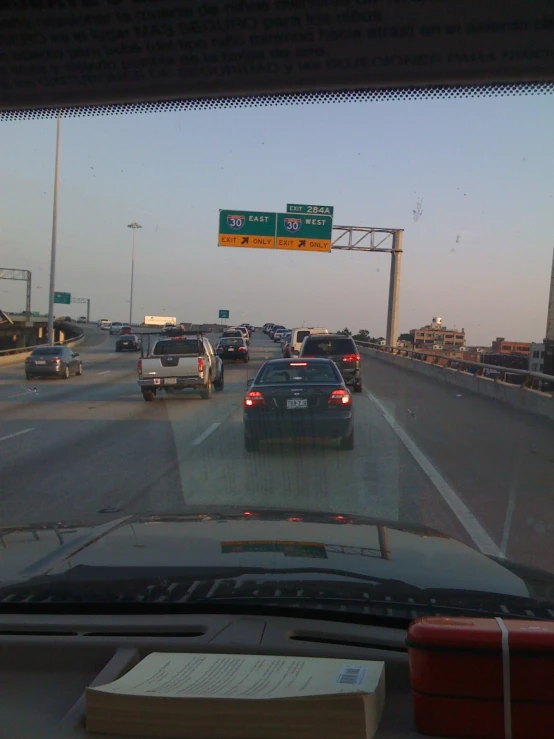 cars are going down a freeway and highway signs