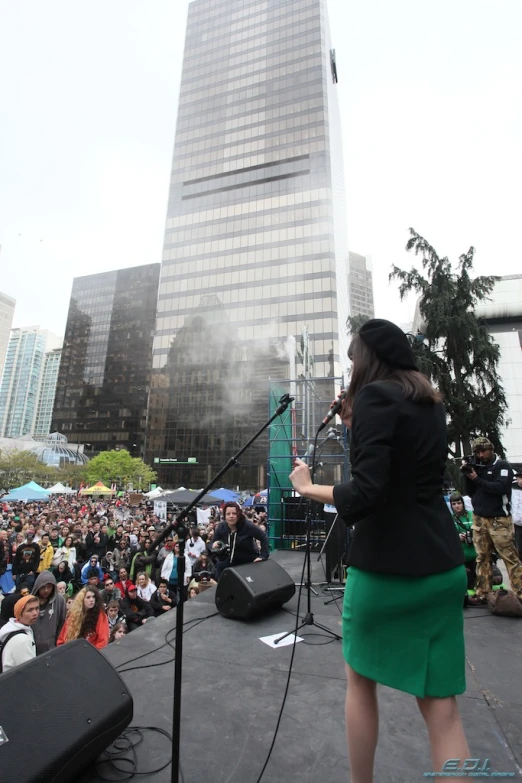 the woman is speaking into a microphone at the microphone