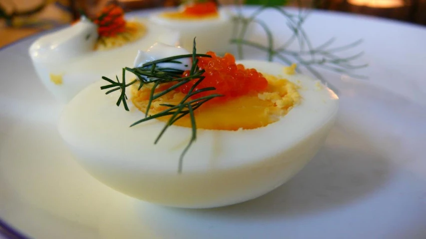 this white plate has eggs with garnish on them