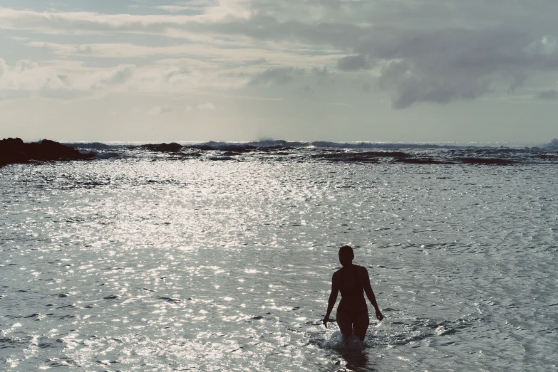 a person walking through a body of water