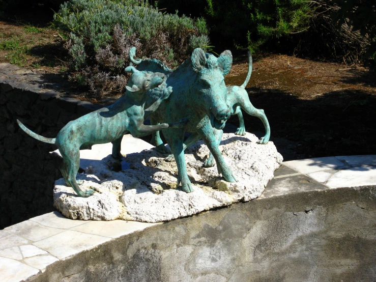 two statues of lions are set on rocks