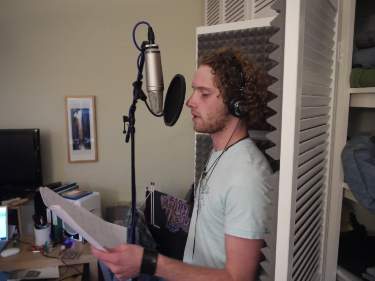 a man in the recording studio reading music