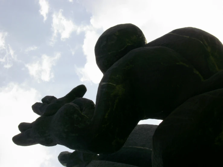 statue made out of clay with sky in background