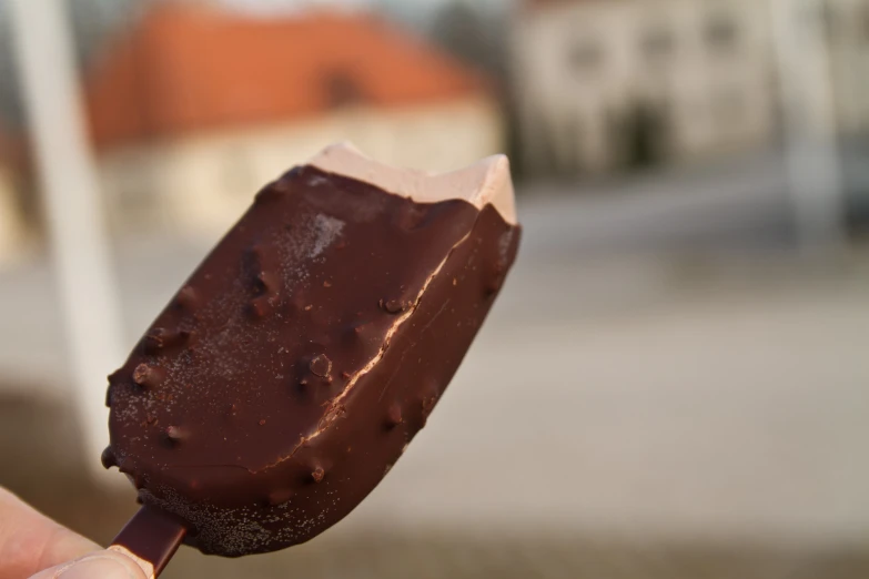 a person is holding up a large popsicle in the air