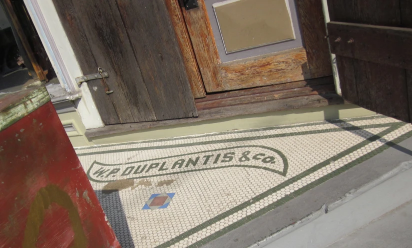 a porch with some wooden doors and a sign on it