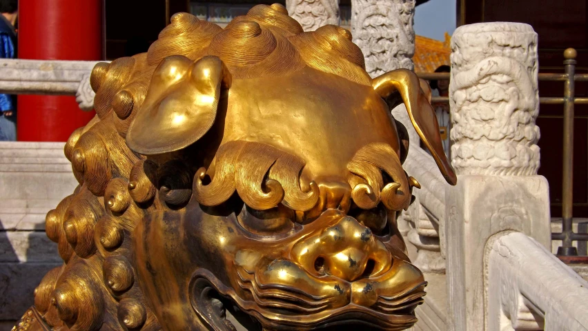 close up of a golden lion head sculpture