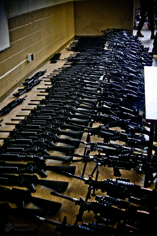 many guns lined up in a large room