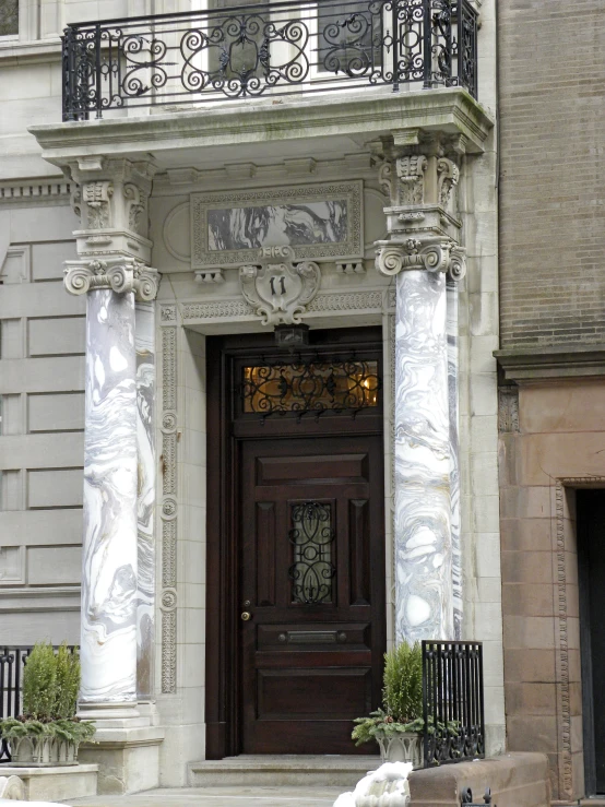 two white dogs laying down next to a door