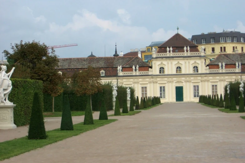 a large palace building with a courtyard and statue