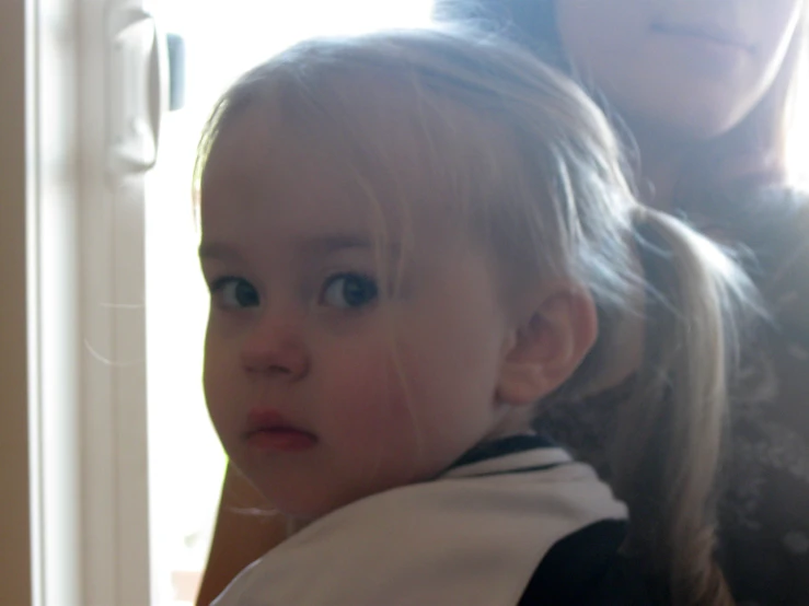 a close up of a child with blonde hair