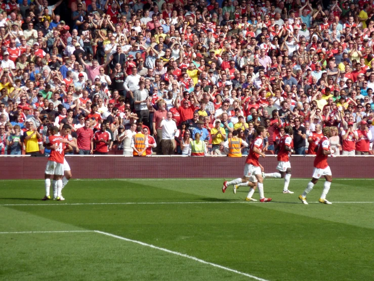 some soccer players are dancing on the field