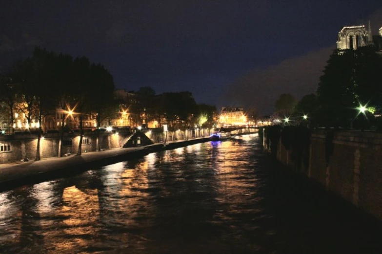 a river runs through a town lit with lights