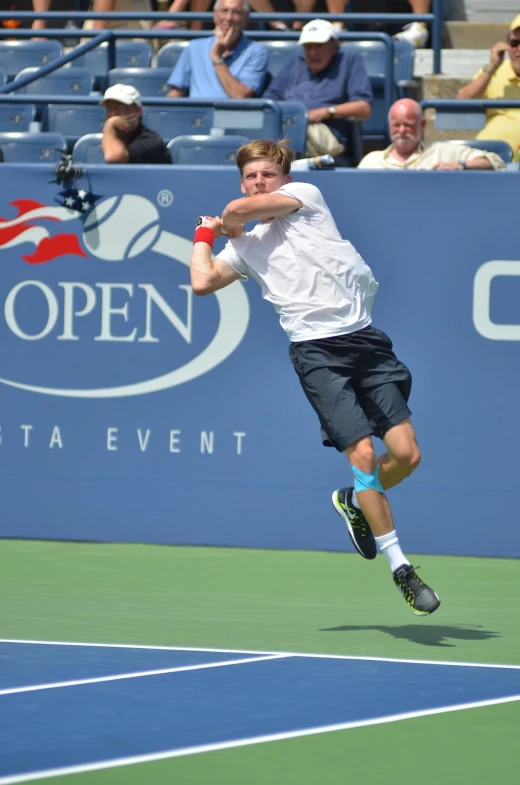 a man hitting a tennis ball with a racquet on a court