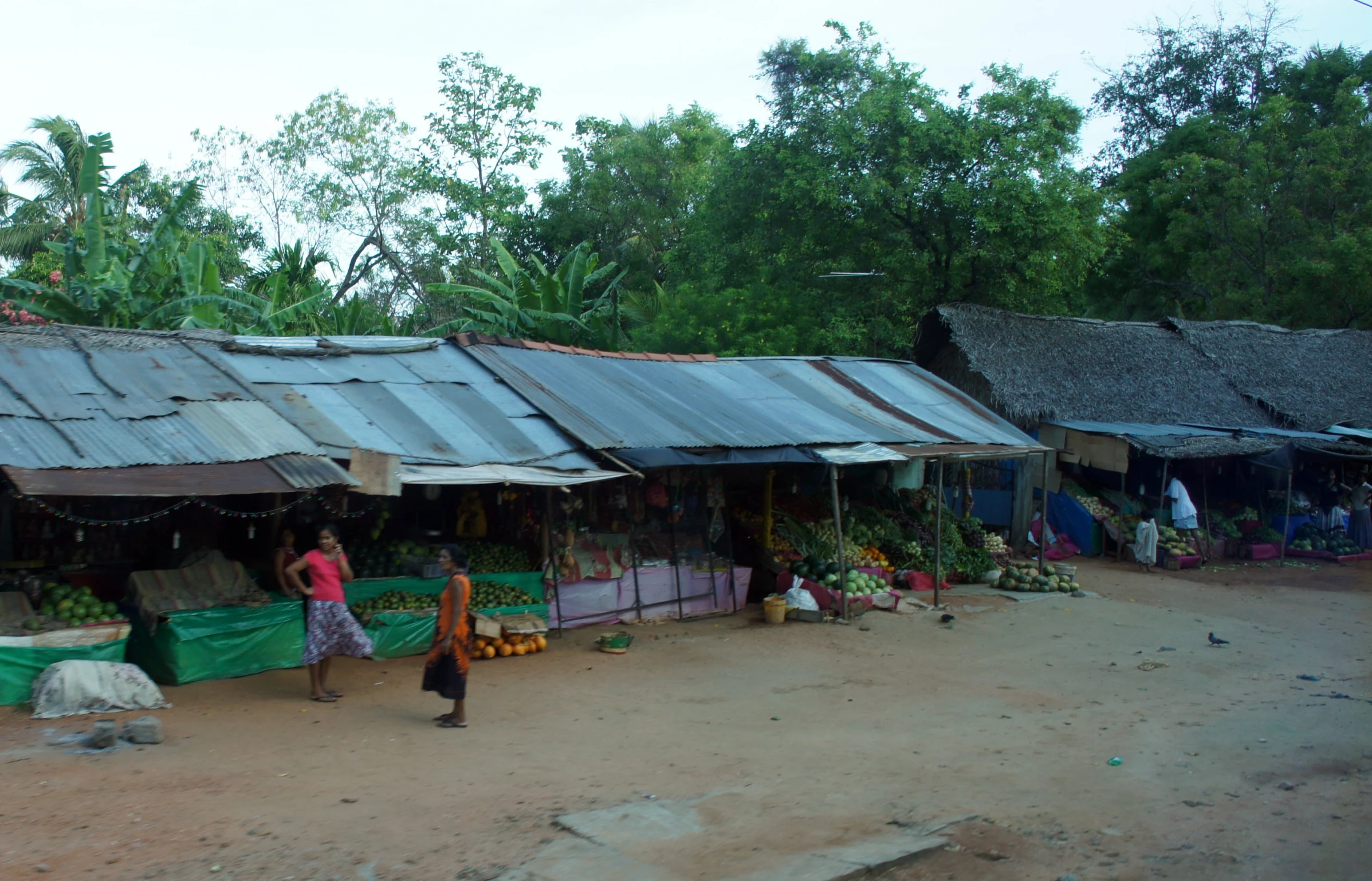 a woman standing in front of a building near other houses