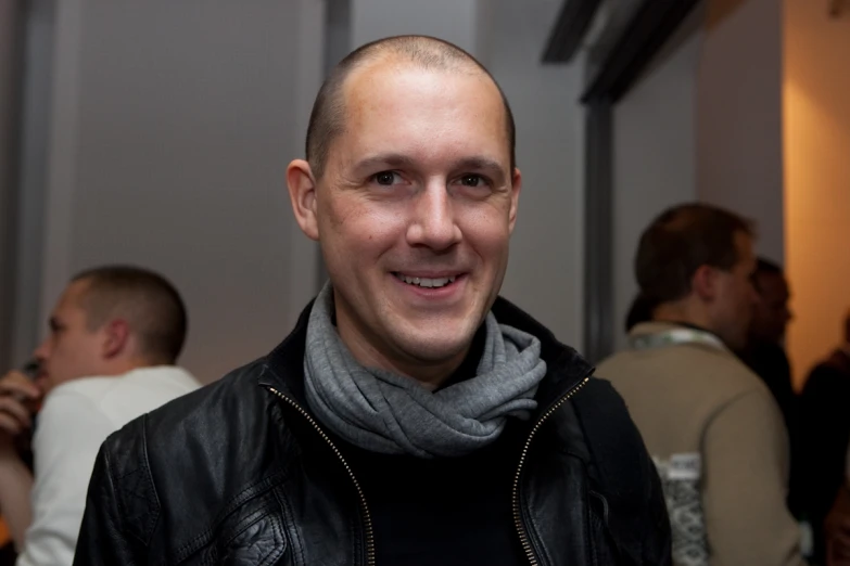 a man wearing a black leather jacket and scarf