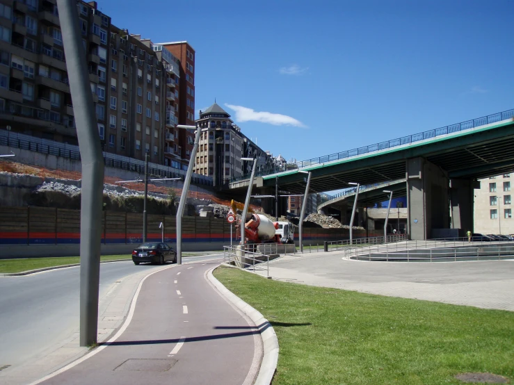 an overpass is visible behind the curve in the road