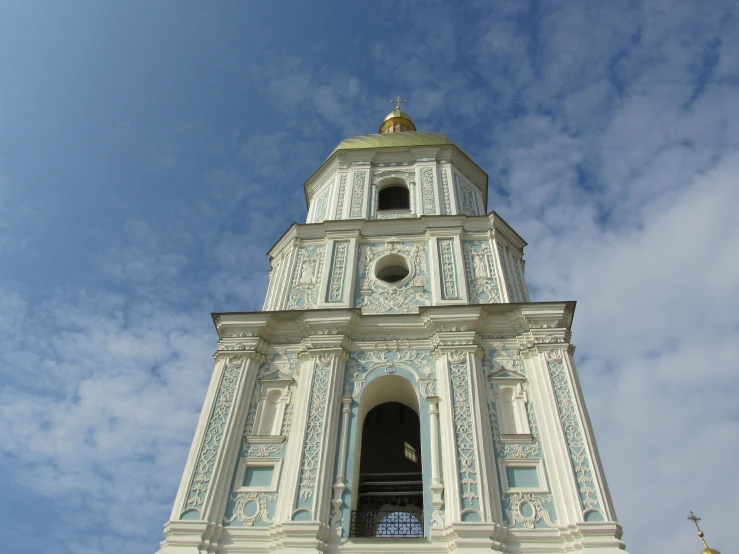 a tall clock tower with a weather vein on the top of it