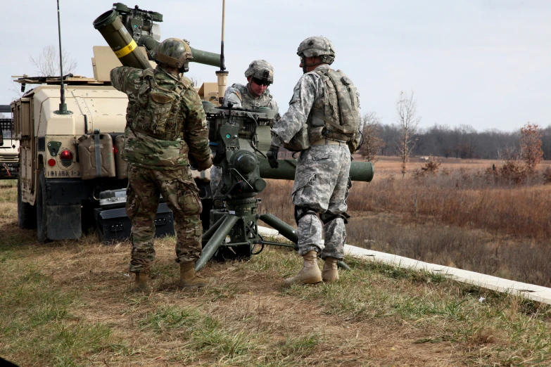 soldiers are gathered around to get a closer look at a military machine