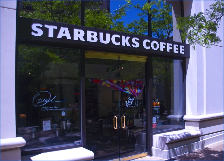 a building with the door open and a sign on it saying starbucks's coffee