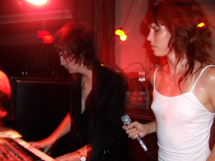 a man standing next to a woman on a stage