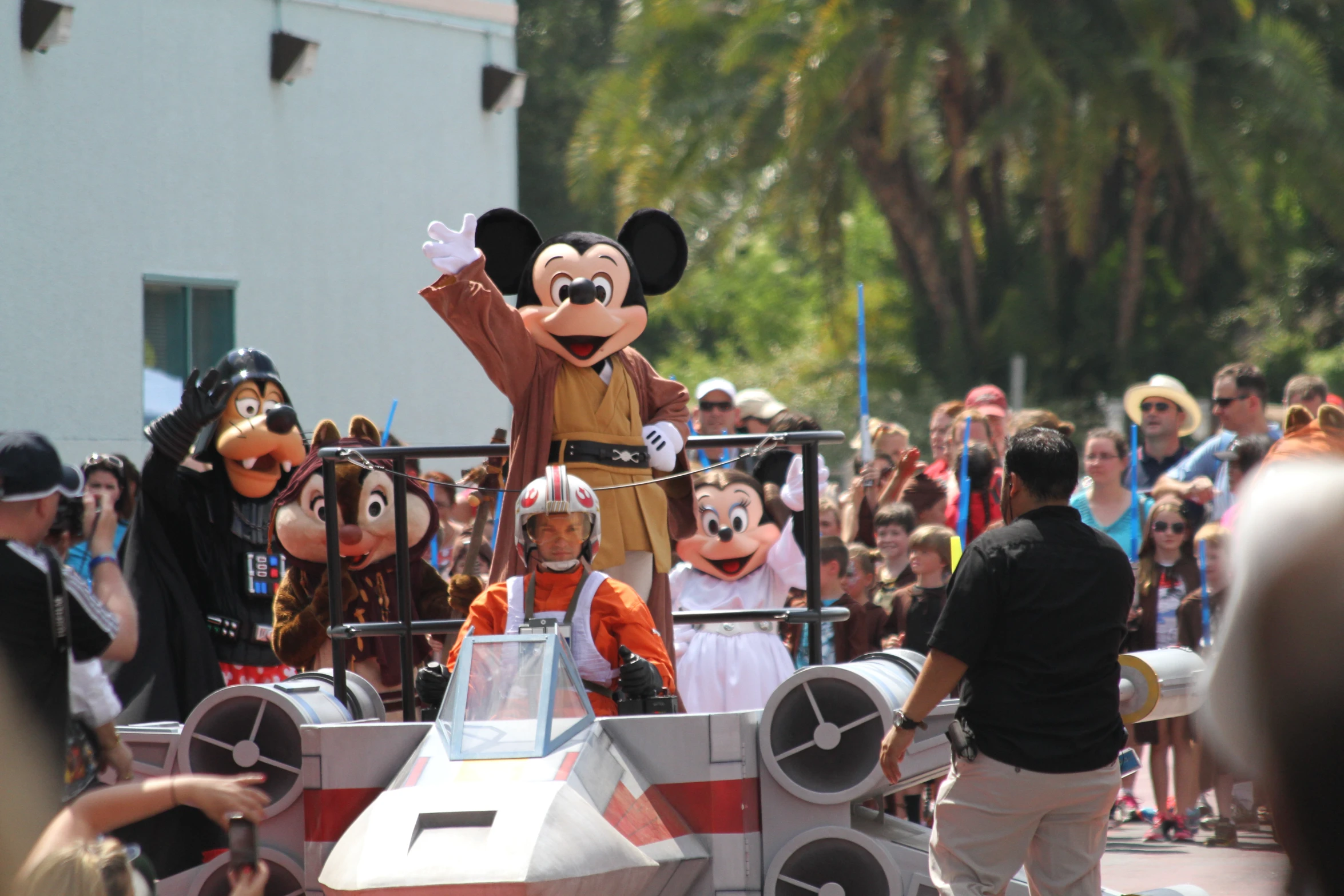 there is a parade with disney characters riding on float