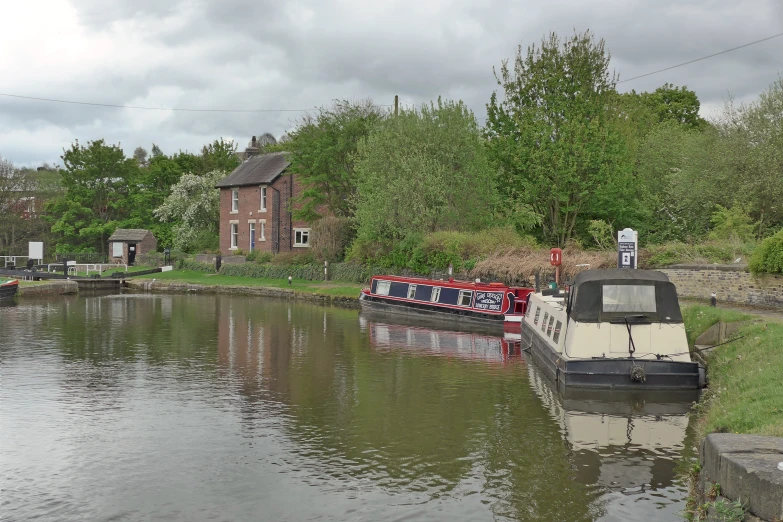 a boat parked next to a boat house on a river