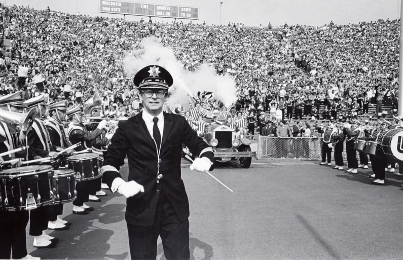 a person in a police uniform near several drums