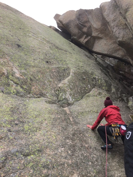 someone on top of a large boulder hill