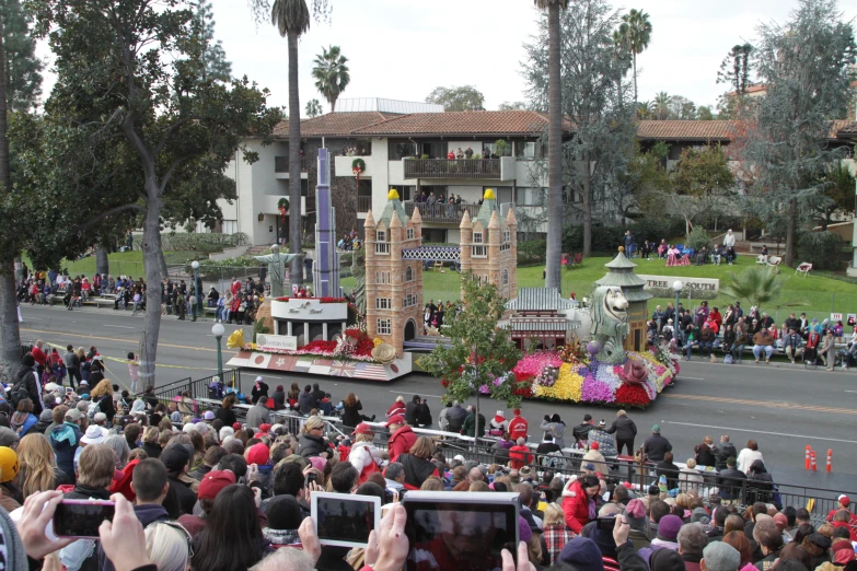 many people are watching a float being ridden by a float