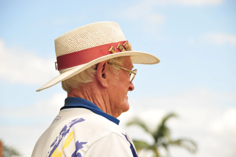 an older man wearing a hat and glasses