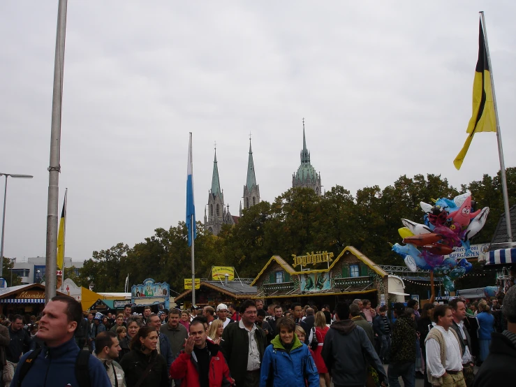 people are gathered at an outdoor carnival or fair