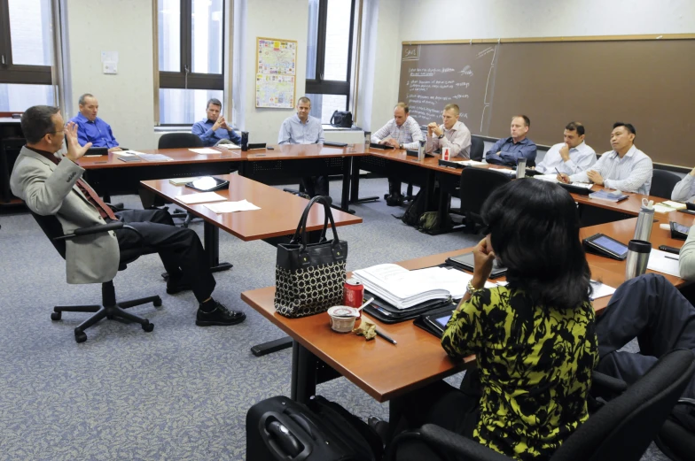 a group of people sitting around a conference table