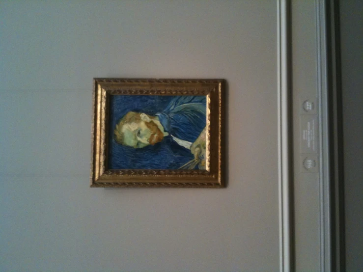 the wall of an art gallery features a portrait of a man