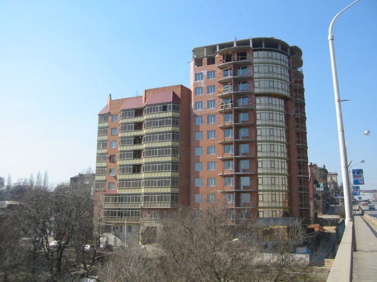 large red brick building sitting on the side of a road